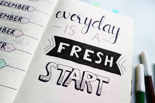 Book note with everyday is a fresh start written inside