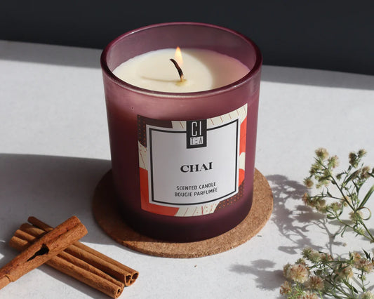 chai candle on a table with cinnamon 