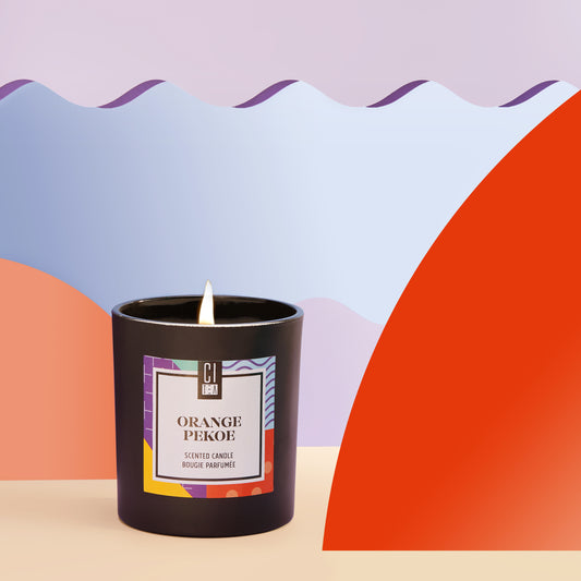 Soy wax candle lighten in front of a colorful background